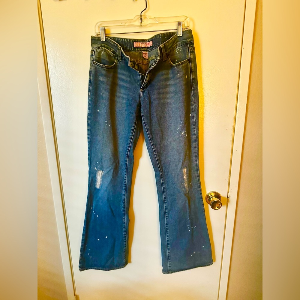 Jade distressed/vintage women’s jeans with holes and paint via the designer.